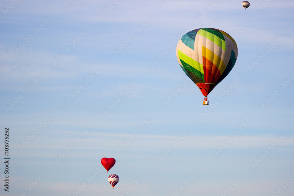 hot air balloon moving up in blue sky. hot air balloon moving up in blue sky.
