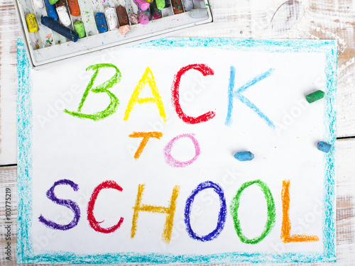 words BACK TO SCHOOL written in blue crayon on paper