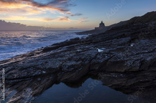 Sun rise on winter morning at Cullernose Point on the coast of Northumberland, England, UK.
