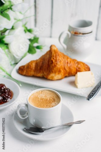 Breakfast with coffee, croissant and strawberry jam