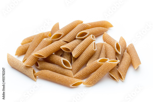 Rye flour macaroni pasta close up isolated on white.