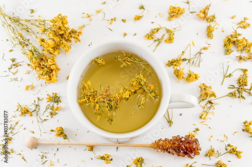 St Johns wort tea and surrounded by dried plants photo