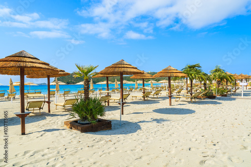 Umbrellas and sunbeds on sandy Villasimius beach, Sardinia island, Italy © pkazmierczak