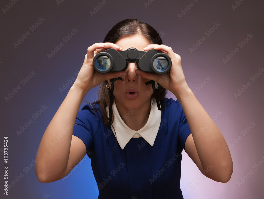 Girl in a blue suit. Keep a binoculars in her hands. Makes gestu Girl in a blue suit. Keep a binoculars in her hands. Makes gestu