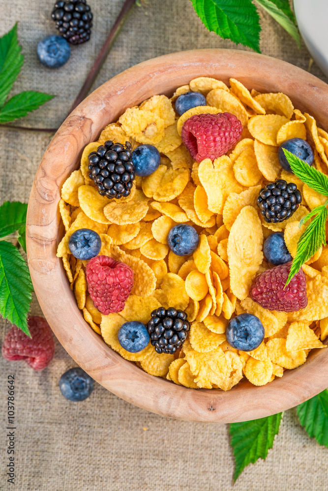 Healthy cornflakes with milk and berry fruits Healthy cornflakes with milk and berry fruits