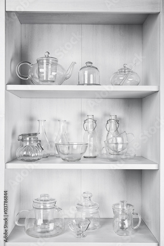Glass dishes on shelves in the kitchen © Africa Studio