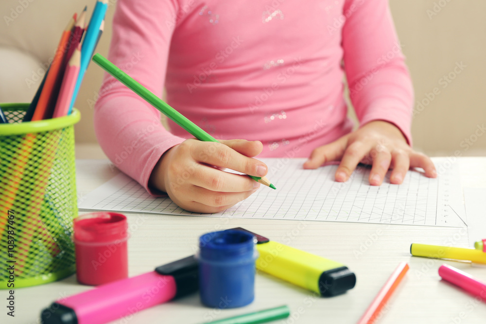 Child drawing with pencils on paper, closeup Child drawing with pencils on paper, closeup