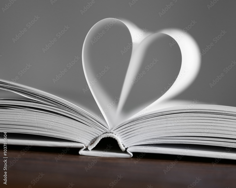 Heart from book pages on green blurred background Heart from book pages on green blurred background