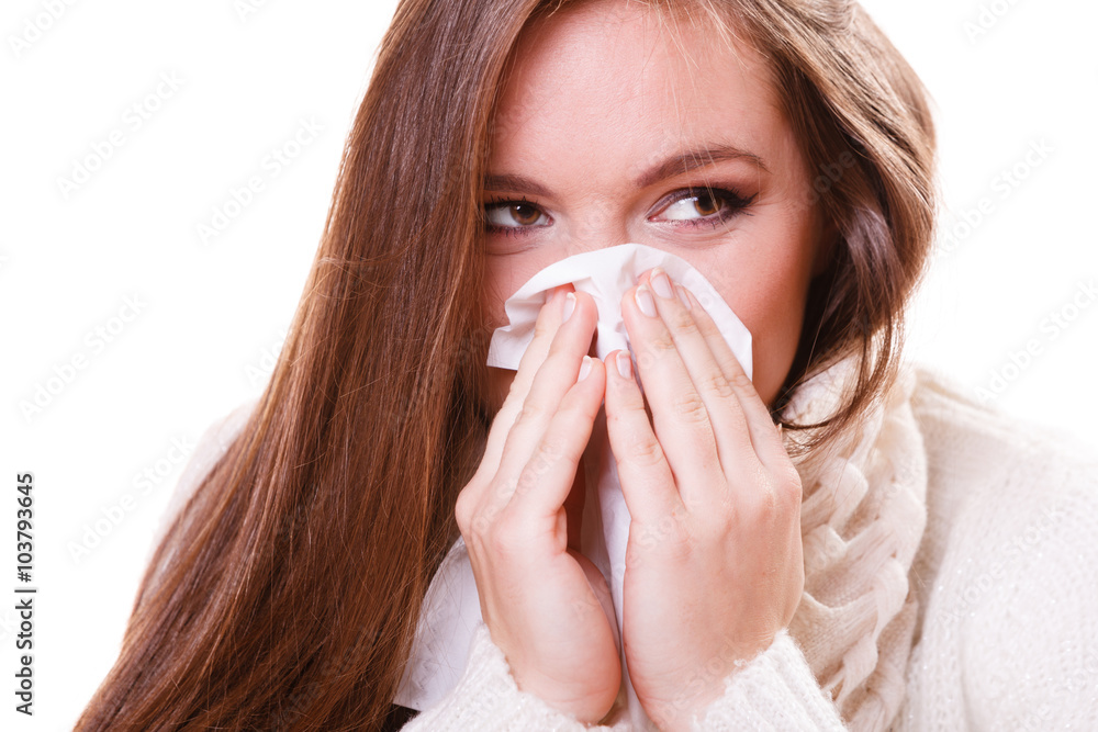 Sick woman girl with fever sneezing in tissue