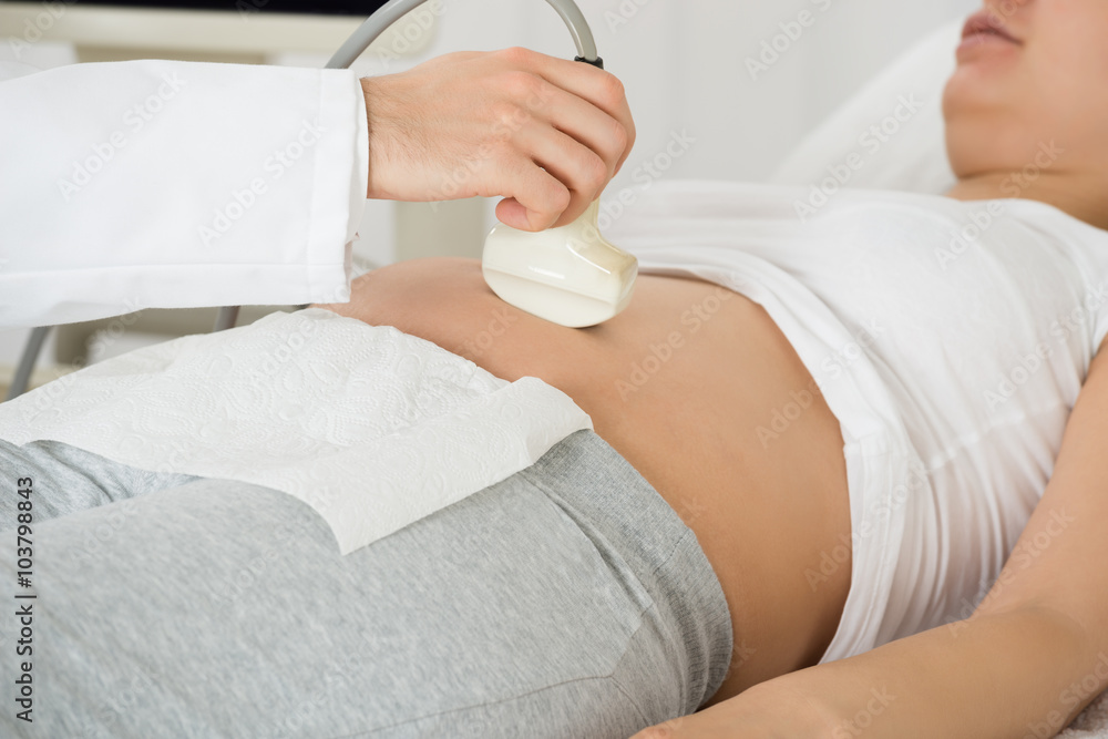 Fototapeta premium Doctor Performing Ultrasound Scan On Expecting Woman