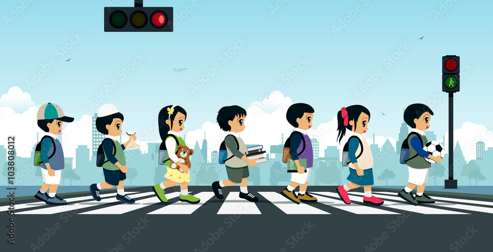 Fotografie Students walking on a crosswalk with a traffic light.