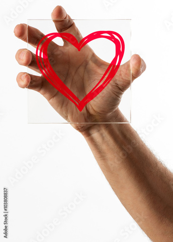 Heart symbol on glass over white background