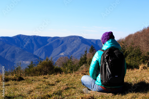 young woman with backpack travel in mountains