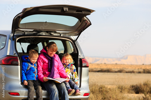 mother with kids looking at map while travel by car © nadezhda1906