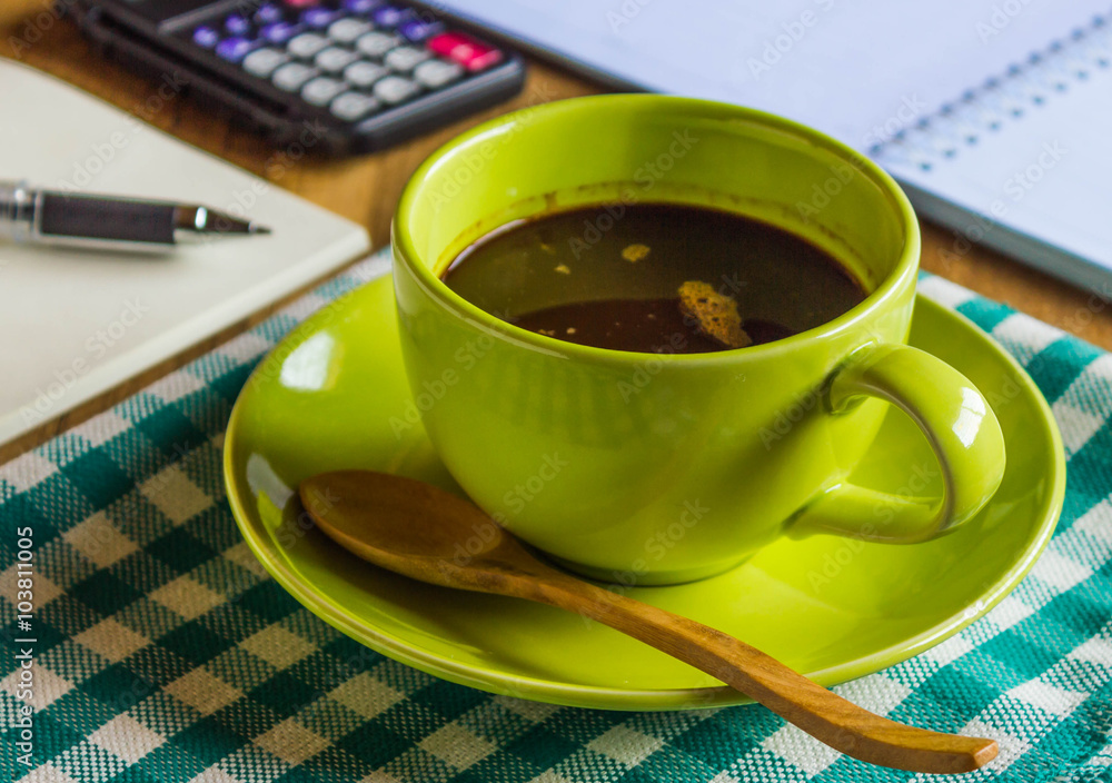Office table with notepad and pen, calculator, cup of coffee and Office table with notepad and pen, calculator, cup of coffee and