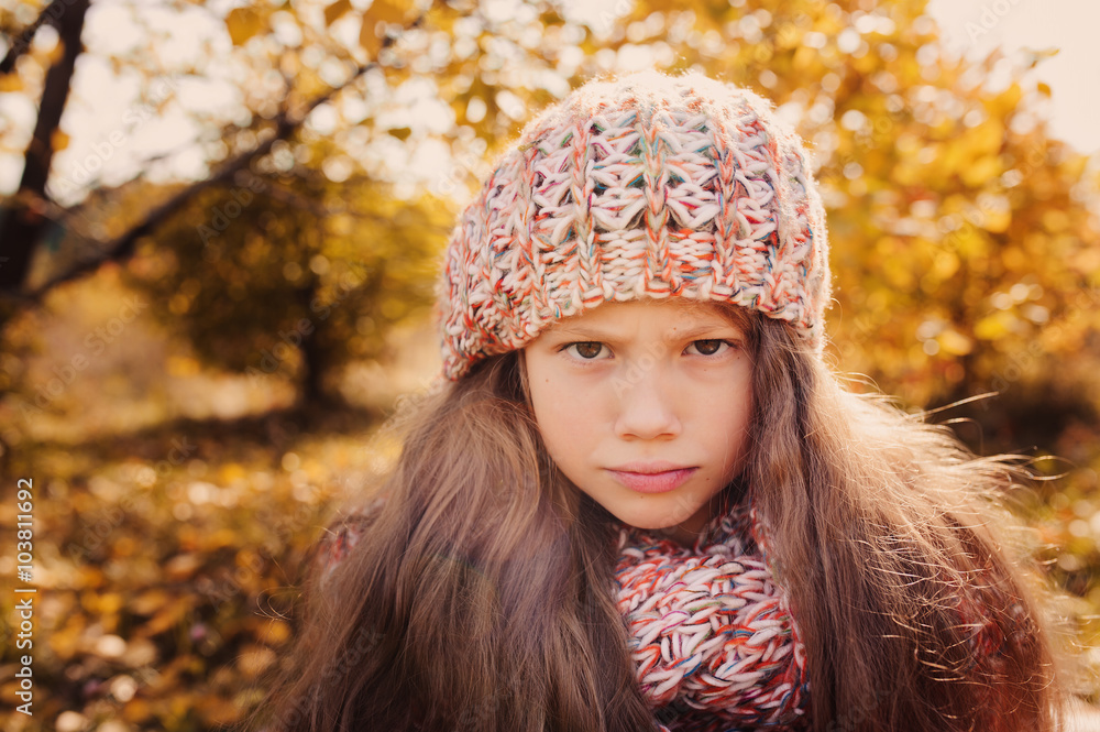 happy child girl in knitted scarf and sweater with basket on autumn walk in forest eating apples. Fall harvest, cozy mood. happy child girl in knitted scarf and sweater with basket on autumn walk in forest eating apples. Fall harvest, cozy mood.