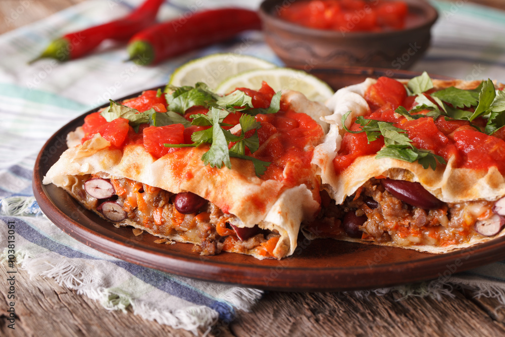 chimichanga with tomato salsa on a plate close-up horizontal
chimichanga with tomato salsa on a plate close-up horizontal