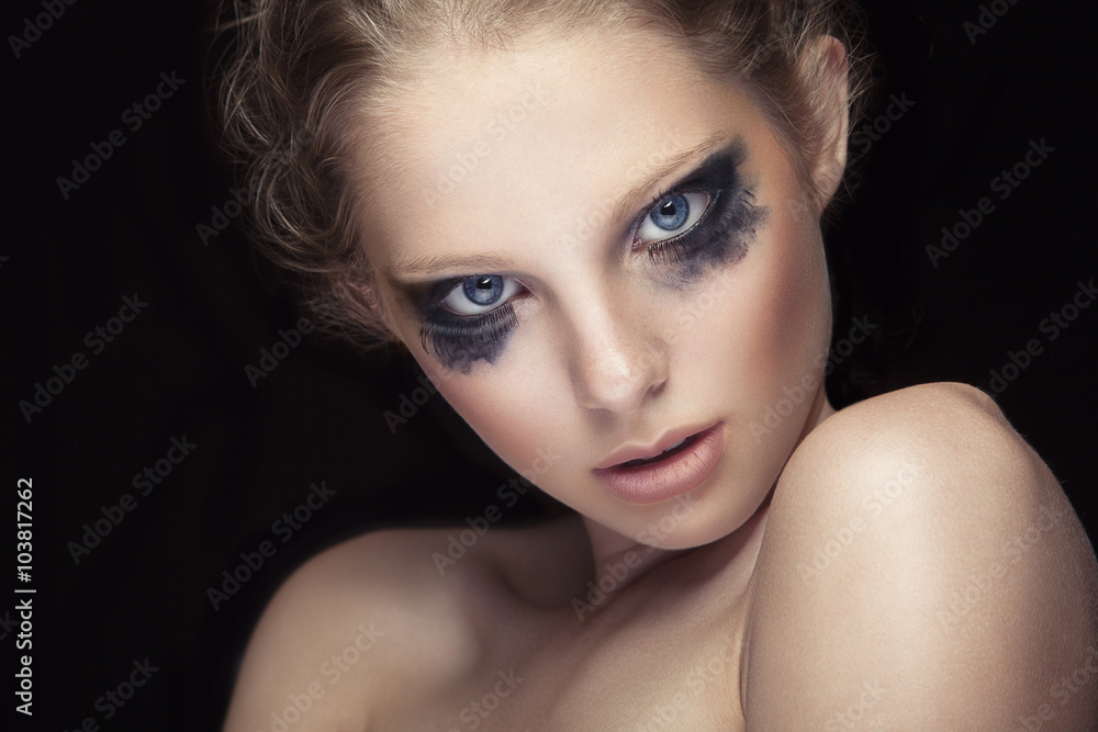 Girl with crying make up on black background Girl with crying make up on black background