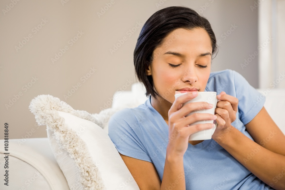 Peaceful brunette drinking by white cup Peaceful brunette drinking by white cup