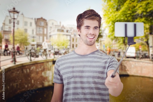 Canvas Print Composite image of happy man taking selfie