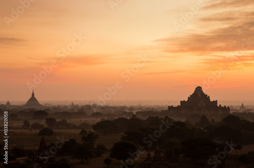 Hot air balloon float over silhouette ancient temple with scenic sunrise orange sky background at Old Bagan   Myanmar