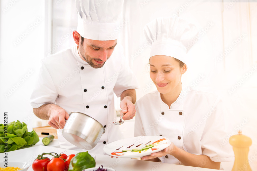 Young attractives professionals chefs cooking together Young attractives professionals chefs cooking together