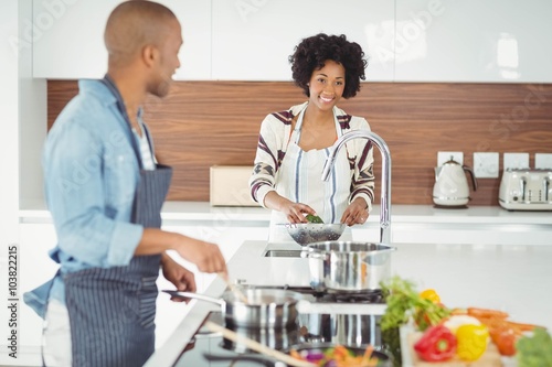 Happy couple preparing meal