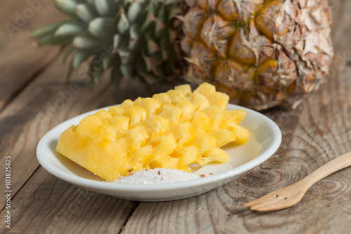Sliced Pineapple on white plate.