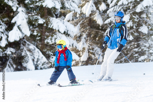 Father and son, preschool child, skiing in austrian ski resort i