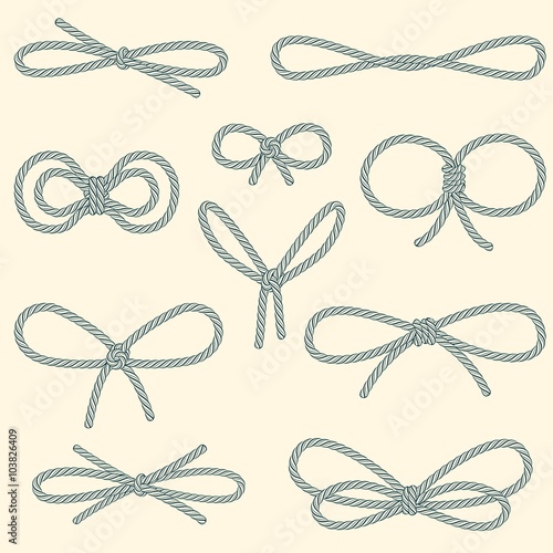 Set of decorative rope bows on beige background