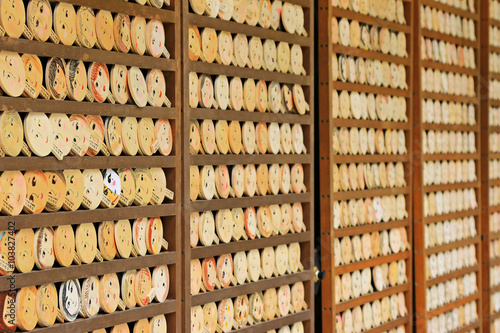 Shallow depth of field of mirror-shaped wooden preyer tablets (called Kagami ema) in Kyoto, Japan. It’s believed to paint the face, make a wish and your face will become more beautiful photo