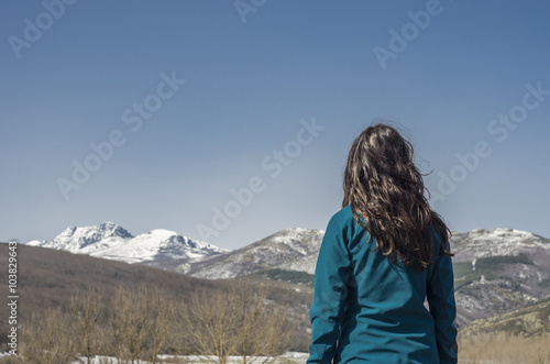 Woman trekking in winter mountains.
