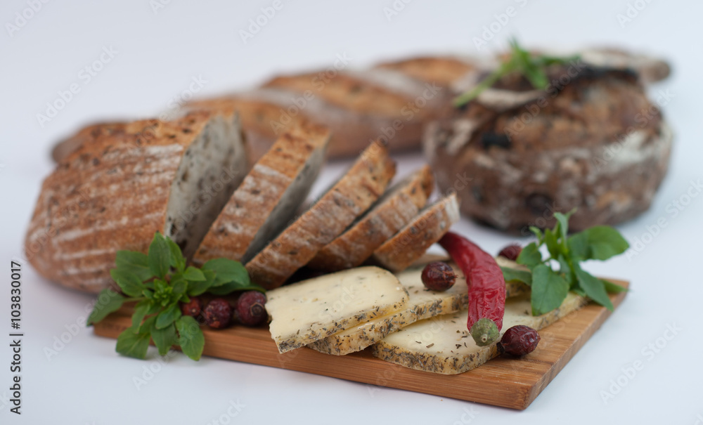 cheese with bread on white dish on brown wooden background