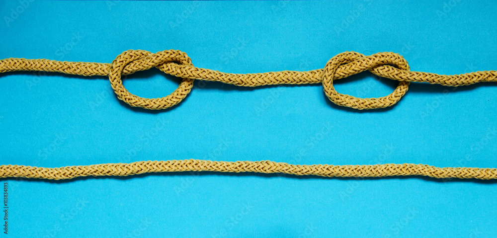 Simple knot on a blue background. Photo of a series of nautical knots. Simple knot on a blue background. Photo of a series of nautical knots.