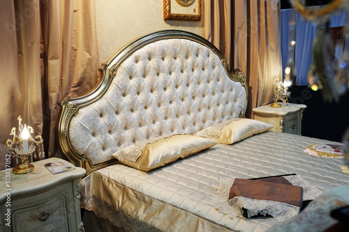 View of bedroom with bed in baroque style