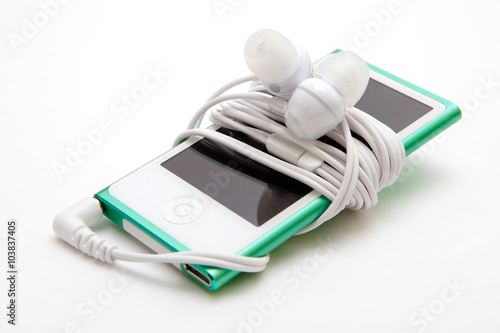 Portable musical player with headphones iisolated on the white