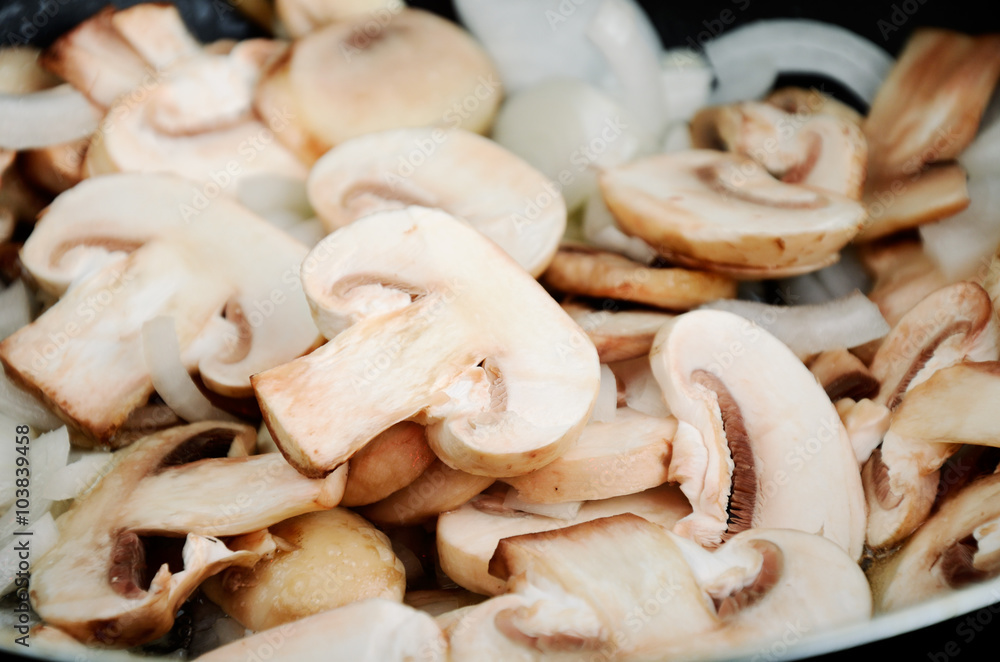 sliced raw mushrooms cooked in a pan. close-up full frame sliced raw mushrooms cooked in a pan. close-up full frame