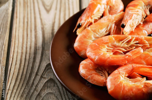 cooked shrimp on a plate on a wooden background close-up