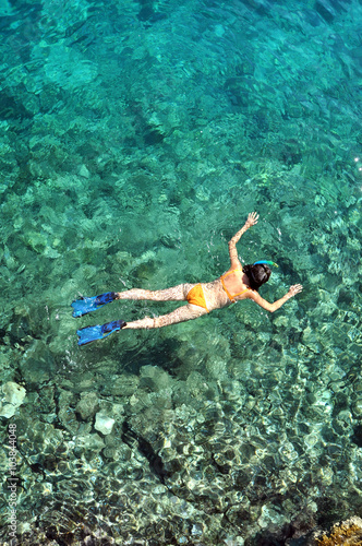 Above view of woman snorkeling in the sea