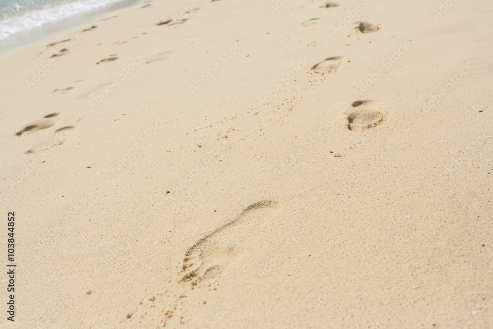 Foot print on a sand beach in sunny day Foot print on a sand beach in sunny day