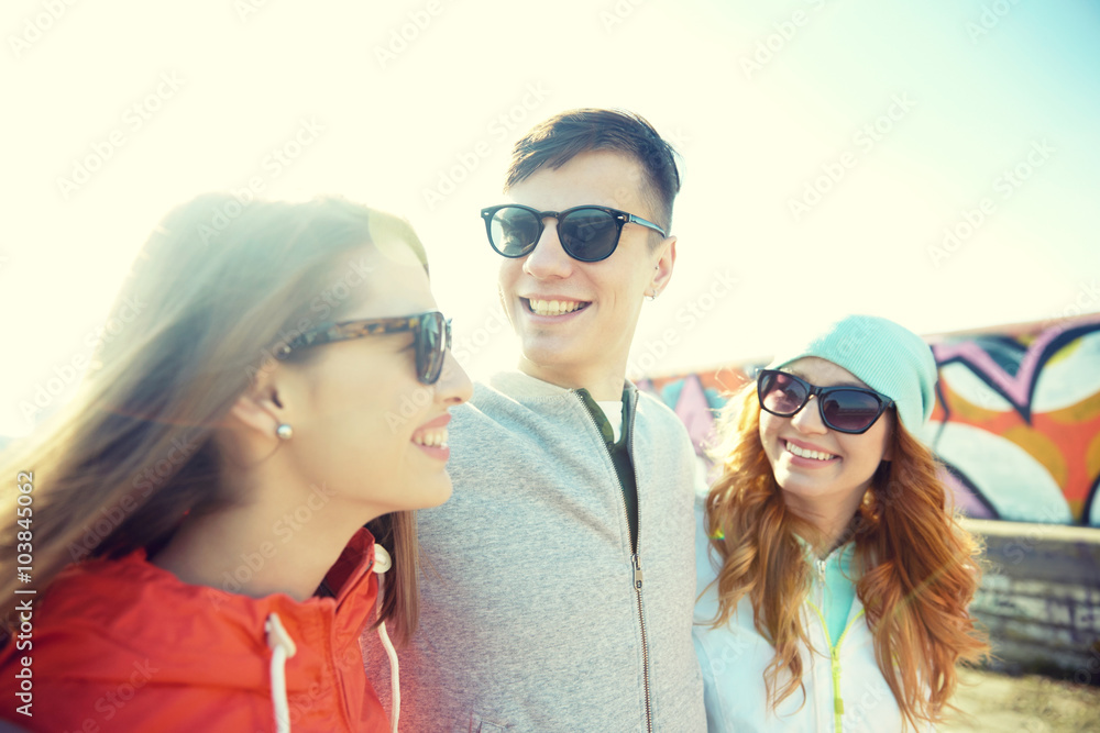 happy teenage friends in shades talking on street happy teenage friends in shades talking on street