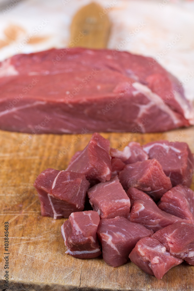 Beef steak cut into cubes. Red meat on the cutting board Beef steak cut into cubes. Red meat on the cutting board