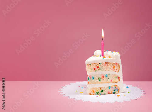 Slice of Birthday Cake with Candle on Pink