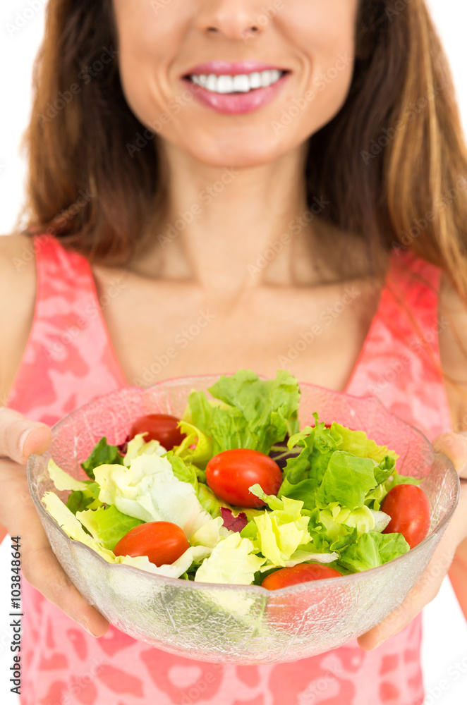 Friendly woman showing a bowl of salad Friendly woman showing a bowl of salad