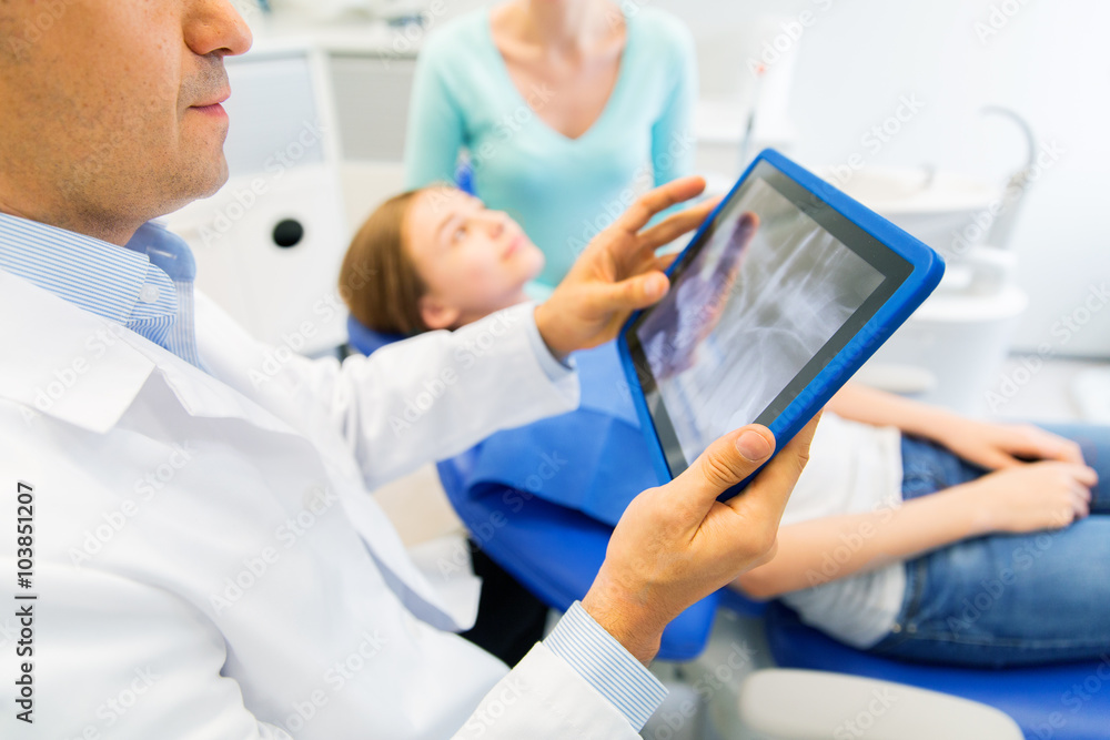 dentist with x-ray on tablet pc with patient girl dentist with x-ray on tablet pc with patient girl