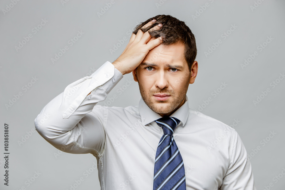 Handsome stylish businessman on grey background Handsome stylish businessman on grey background