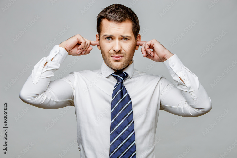 Handsome stylish businessman on grey background Handsome stylish businessman on grey background