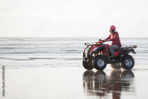 Happy ATV driver on the Ninety Mile Beach, New Zealand