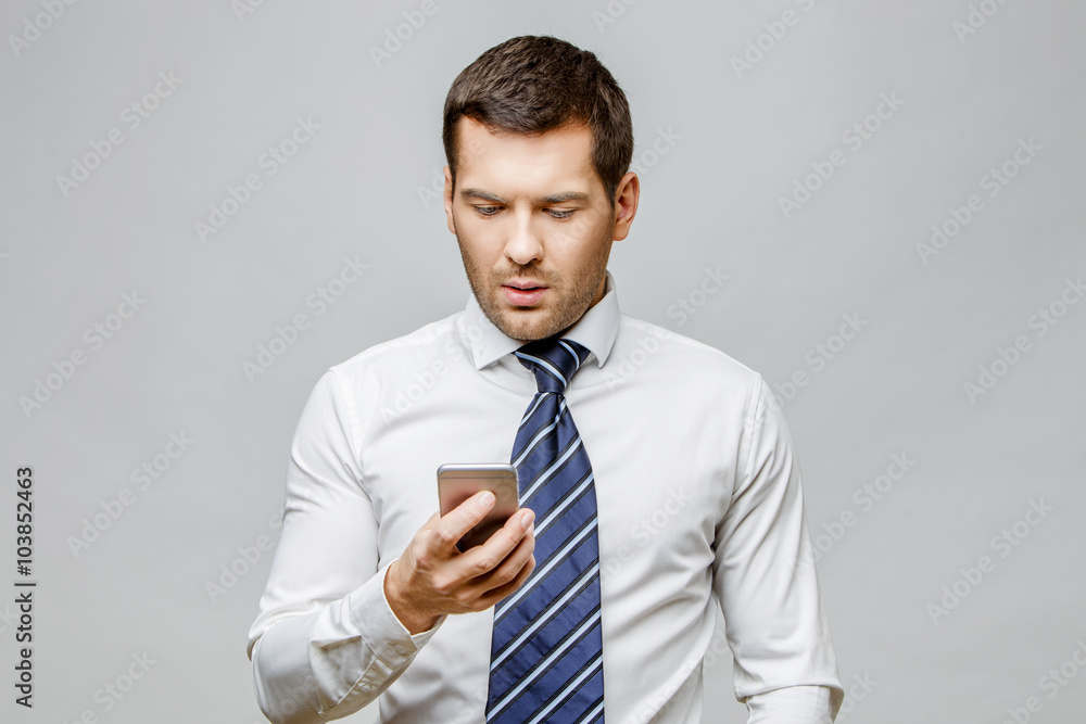 Handsome stylish businessman on grey background Handsome stylish businessman on grey background