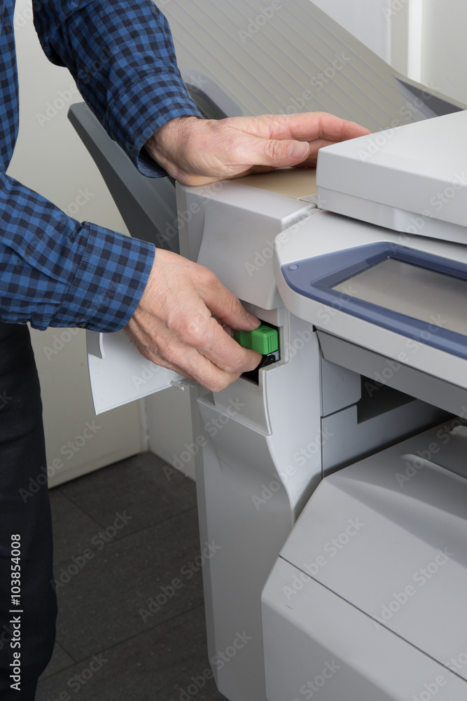Handyman fixing the office printer at work Handyman fixing the office printer at work